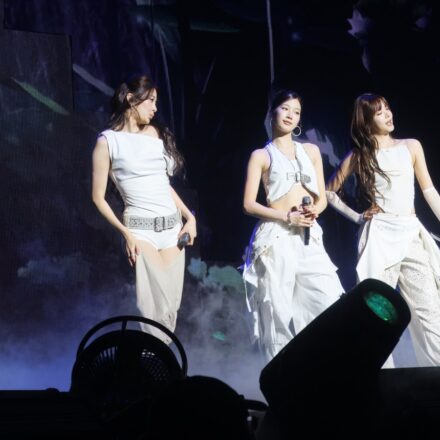 Five members of LE SSERAFIM performing on stage in Seattle in 2025.